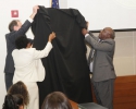 Artist Harold Davis and Judge and Elaine Adams unveil the portrait